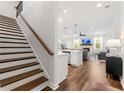 Bright, open floor plan featuring wood floors, a modern kitchen, and a cozy living area with fireplace at 1316 Willamette Way, Marietta, GA 30008