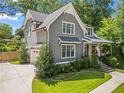 Angle exterior view showcases the home's gray siding, white trim, attached garage, and landscaped front yard at 2922 Parkridge Ne Dr, Brookhaven, GA 30319
