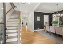 Bright foyer with hardwood floors, staircase, and dining room with dark accent wall, offering a stylish welcome at 2922 Parkridge Ne Dr, Brookhaven, GA 30319