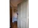 An inviting, light gray front door with gold accents opens to a home with warm hardwood floors and a bright white desk at 37 La Rue Nw Pl, Atlanta, GA 30327