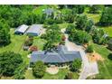 Stunning aerial view of estate, outbuildings, and surrounding landscape on beautifully manicured acreage at 3700 Tom Brewer Rd, Loganville, GA 30052