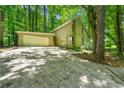 Exterior view of home featuring an attached two-car garage and ample parking at 70 Juliana Dr, Ellenwood, GA 30294