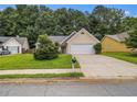 Traditional home features a well-manicured lawn, mature trees, and a private driveway at 1055 Avalon Dr, Lawrenceville, GA 30044