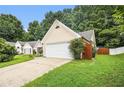 Lovely one story home showing two car garage and a well-maintained lawn at 1055 Avalon Dr, Lawrenceville, GA 30044