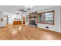 Inviting living room featuring hardwood floors and a stone fireplace at 1189 E Fayetteville Rd, Riverdale, GA 30296
