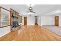 Bright and spacious living room with hardwood floors and stone fireplace at 1189 E Fayetteville Rd, Riverdale, GA 30296