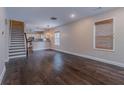 Spacious living room featuring hardwood floors and a modern open layout to kitchen at 1555 New Ne St, Atlanta, GA 30307