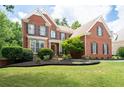 Beautiful brick home with manicured lawn and mature landscaping at 3045 Moss Stone Lane Sw Ln, Marietta, GA 30064