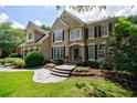 Beautiful two-story home with lush landscaping and a stone walkway to the front door at 4310 Granby Way, Marietta, GA 30062