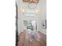 Bright foyer with high ceiling, chandelier, and wood flooring at 113 Laurel Brook Ln, Canton, GA 30115