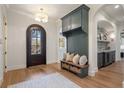 Inviting mudroom with custom cabinets, bench seating, and arched doorway at 113 Laurel Brook Ln, Canton, GA 30115