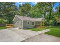 Inviting home boasting a spacious driveway, well-manicured lawn, and a charming porch perfect for relaxing in the serene environment at 1675 White Oak Way, Decatur, GA 30032