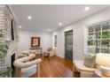Sunlit living room features hardwood floors, a decorative fireplace, comfortable seating, and ample natural light at 814 S Mcdonough St, Decatur, GA 30030