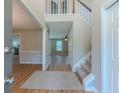 Bright entryway with wood floors, staircase, and views into the living spaces at 1904 Watercrest Cir, Lawrenceville, GA 30043