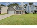 Traditional home with a lawn and driveaway and porch at 1904 Watercrest Cir, Lawrenceville, GA 30043
