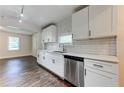 The updated kitchen showcases white cabinets, stainless steel appliances, and lots of light at 1914 North Nw Ave, Atlanta, GA 30318