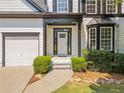 Close-up view of the home's front entrance, highlighting the front door, stone accents, and manicured bushes at 275 Springs Xing, Canton, GA 30114