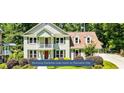 Stunning Peachtree Lake home in Peachtree City with traditional architecture and manicured lawn at 115 Edgewater Way, Peachtree City, GA 30269