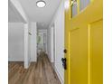 Bright entryway with hardwood flooring, white trim, and a distinctive yellow front door at 1400 North Avenue Nw, Atlanta, GA 30318