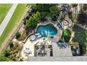 Aerial view of a luxurious backyard pool with waterfall, stone patio, dining area, and lounge chairs at 2380 Tayside Nw Xing, Kennesaw, GA 30152