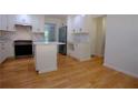 Bright kitchen with white cabinets, stainless steel appliances, marble countertops, and new hardware at 260 Lakemont Dr, Roswell, GA 30075