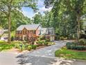 Charming two-story brick home with a long driveway and beautifully landscaped front yard at 3506 Billingsley Dr, Marietta, GA 30062