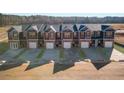 Aerial view of modern townhomes with well-manicured lawns and paved driveways at 229 Ivey Ter # 37, Temple, GA 30179