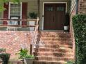 Inviting front entrance with brick steps, wooden doors, and decorative plants showcasing curb appeal at 4094 Carlisle Pl, Stone Mountain, GA 30083