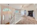 Bright living room featuring a fireplace, large window, and staircase at 113 Hitchcock Dr, Villa Rica, GA 30180