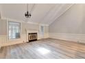 Cozy living room with a fireplace, lots of light, and light, modern flooring at 440 Forestgate Ct, Atlanta, GA 30350