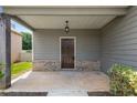 Charming front porch with brick foundation and hanging light fixture at 1212 Ithaca Dr, Mcdonough, GA 30253