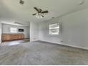 Spacious living room featuring carpet flooring, a ceiling fan and a kitchenette at 14367 Fincher Rd, Canton, GA 30114