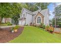 Beautiful home featuring stone accents, manicured lawn, and a charming, inviting entrance at 722 Ivory Trl, Woodstock, GA 30188