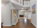 Spacious foyer with hardwood floors, coat rack, and view of the living spaces at 722 Ivory Trl, Woodstock, GA 30188