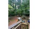 Spacious backyard with mature trees and a wooden deck at 974 Bloomfield Dr, Lawrenceville, GA 30044
