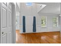Bright foyer with hardwood floors, white walls, and a high ceiling with large windows at 1048 Falls Brooke Dr, Conyers, GA 30094