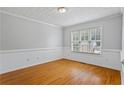 Inviting living room with natural light, hardwood floors, and neutral paint at 1048 Falls Brooke Dr, Conyers, GA 30094
