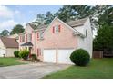 Brick home featuring well-maintained landscaping and a two-car garage with driveway at 1137 Misty Valley Ct, Lawrenceville, GA 30045