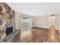 Inviting living room with stone fireplace and access to a private balcony at 124 Camelot Dr, Atlanta, GA 30349