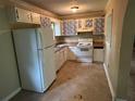 Functional kitchen with white appliances, light countertops, cabinets, and an adequate floor space at 718 Hardy Way, Hiram, GA 30141