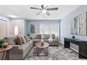 Cozy living room with two sofas, a ceiling fan, and large windows at 1694 Pheasant Dr, Atlanta, GA 30238