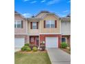 Inviting townhome with brick facade, tidy landscaping, and private garage at 2083 Hasel St, Lawrenceville, GA 30044