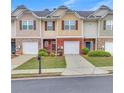 Attractive townhomes featuring brick and siding exteriors, with well-manicured lawns and driveways, in a desirable neighborhood at 2083 Hasel St, Lawrenceville, GA 30044