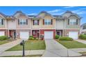 Attractive townhome exteriors include individual garages, mature landscaping, and concrete driveways at 2083 Hasel St, Lawrenceville, GA 30044
