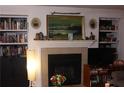 Living room featuring a fireplace, mantle with decor, shelves, and a tv at 2697 Vinings Central Dr # 61, Atlanta, GA 30339