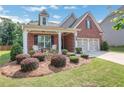 Inviting front porch with chairs and beautiful landscaping adds curb appeal at 2980 Prestwood Dr, Cumming, GA 30040