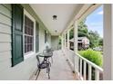 Cozy covered porch with outdoor seating and a view of the neighborhood and surrounding landscaping at 3359 Villa Ln, Douglasville, GA 30135