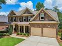 Beautiful brick home with a two-car garage, manicured lawn, and landscaped front yard at 5511 Highland Preserve Dr, Mableton, GA 30126