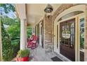 Cozy front porch with rocking chairs, brick flooring, and a welcoming entrance at 5511 Highland Preserve Dr, Mableton, GA 30126