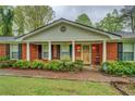 Close-up of a brick home with a covered entryway and well-maintained landscaping at 1349 Springwood Nw Dr, Conyers, GA 30012